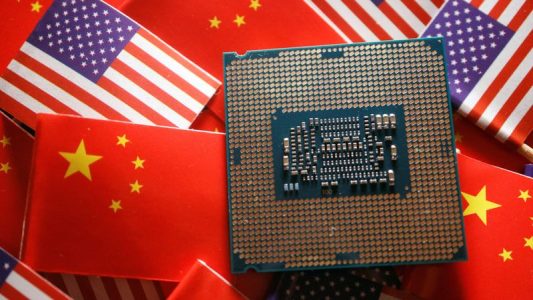 FILE PHOTO: A central processing unit (CPU) semiconductor chip is displayed among flags of China and U.S., in this illustration picture taken February 17, 2023. REUTERS/Florence Lo/Illustration